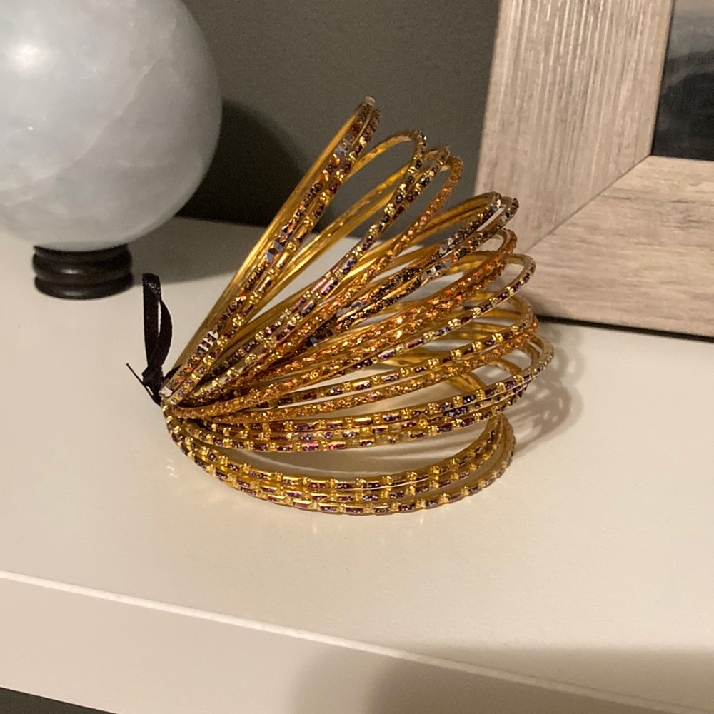 BNWOT set of costume jewelry bangles. Beautiful orange/rainbow colours!